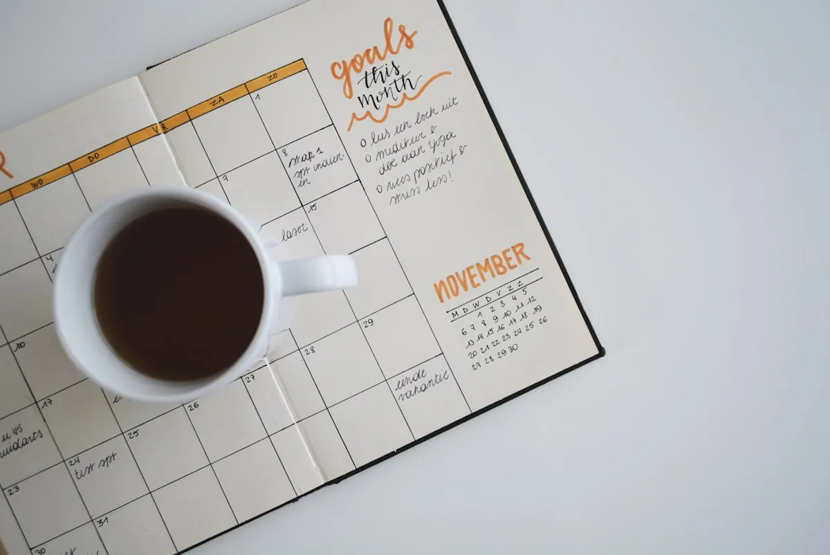 An hourglass on a desk next to a keyboard, representing compliance deadlines and regulatory timing.