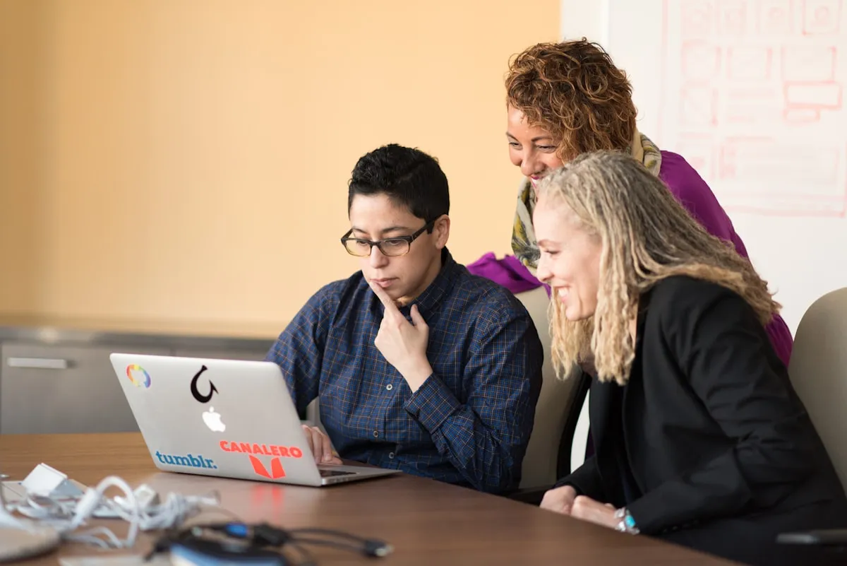 A person searching for answers on a laptop, with question mark icons representing common FAQ topics.